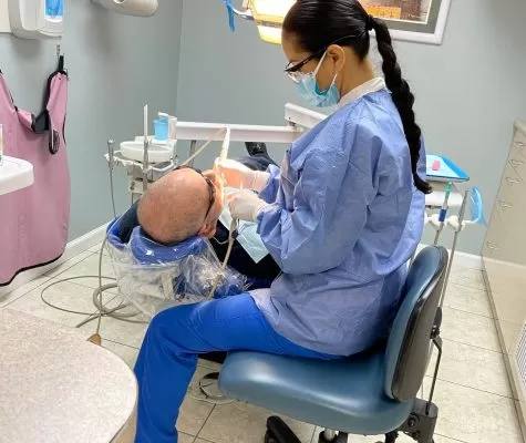 An RNS Dental hygienist during a dental cleaning
