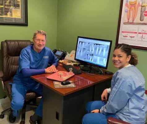 Dr. Russo reviewing dental X-rays with an RNS Dental team member