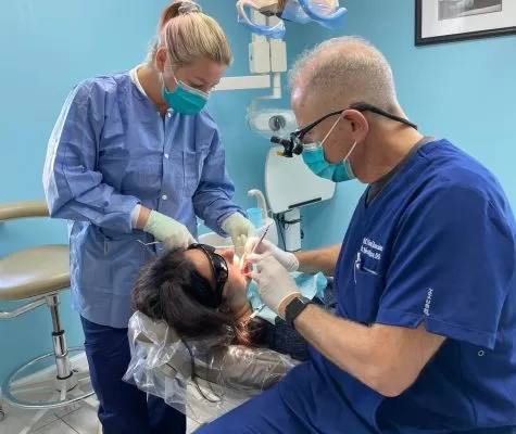 Dr. Shulman and an assistant performing a dental procedure